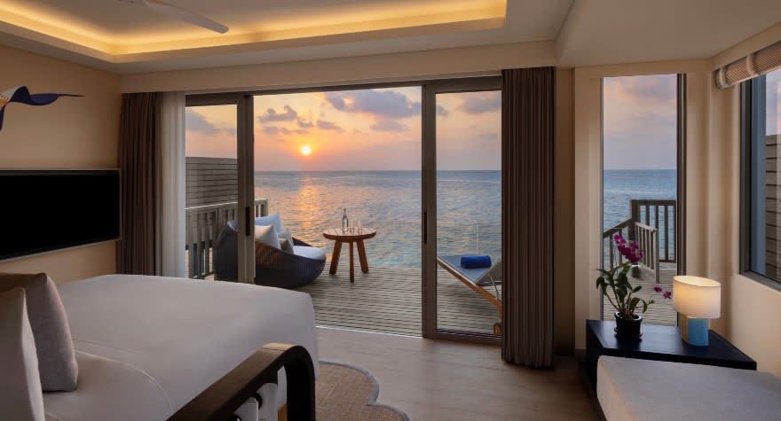 Avani Sunset Over Water Villa Bedroom at Avani+ Fares Maldives Resort
