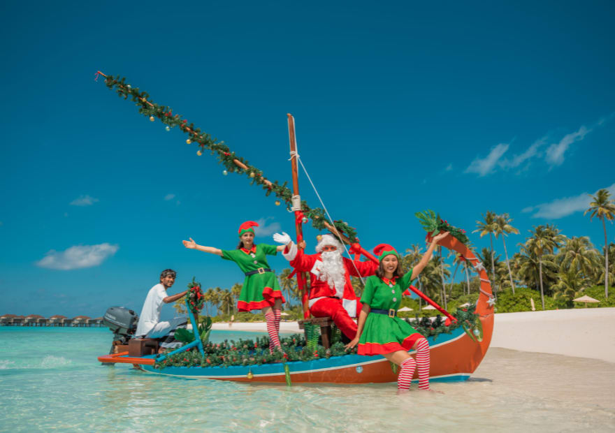 Santa and the elves on a Maldivian dhoni at Avani+ Fares Maldives Resort