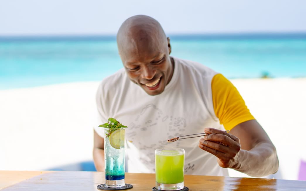 Bartender making cocktails at Tribe Bar - Avani+ Fares Maldives Resort