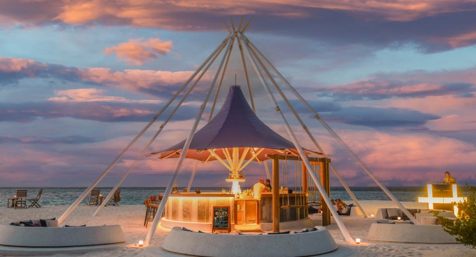 Sunset view of the Tribe Bar - Avani+ Fares Maldives Resort