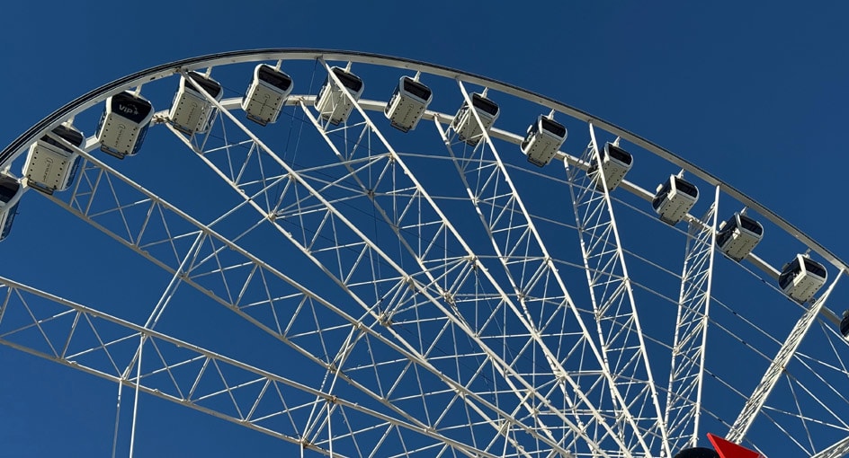 Close-up view of the Wheel of Brisbane gondolas against a clear blue sky, highlighting the white steel structure and modern observation cabins.