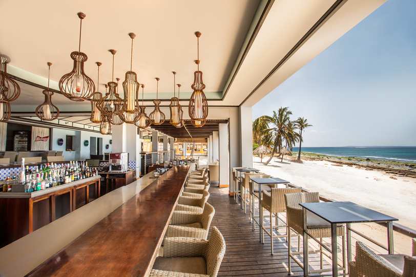 A beachfront restaurant, overlooking white sand and turquoise water