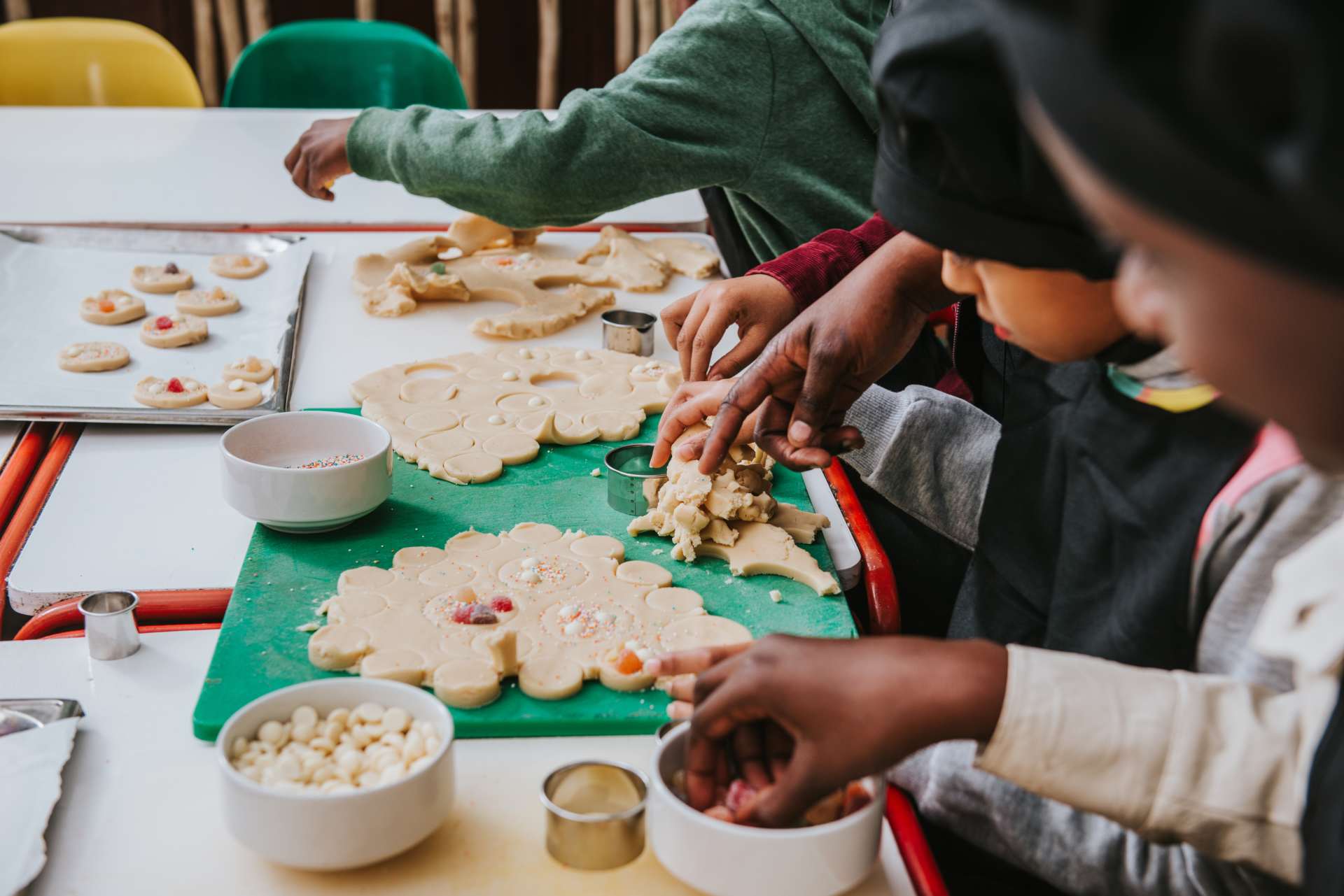 A child participating in cookie decorating.