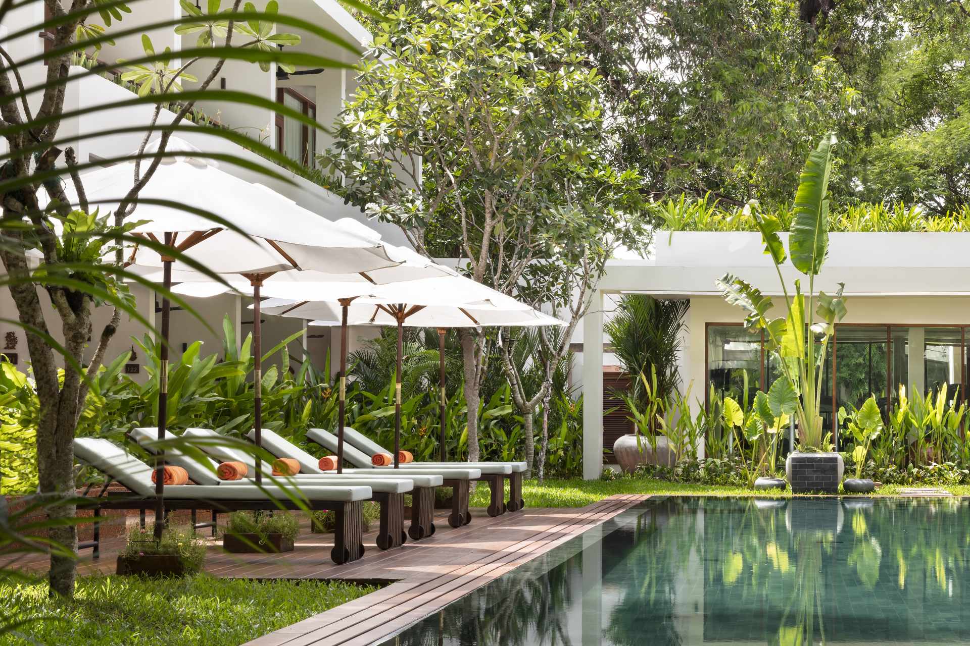 Sunbeds by the pool at FCC Angkor by Avani.