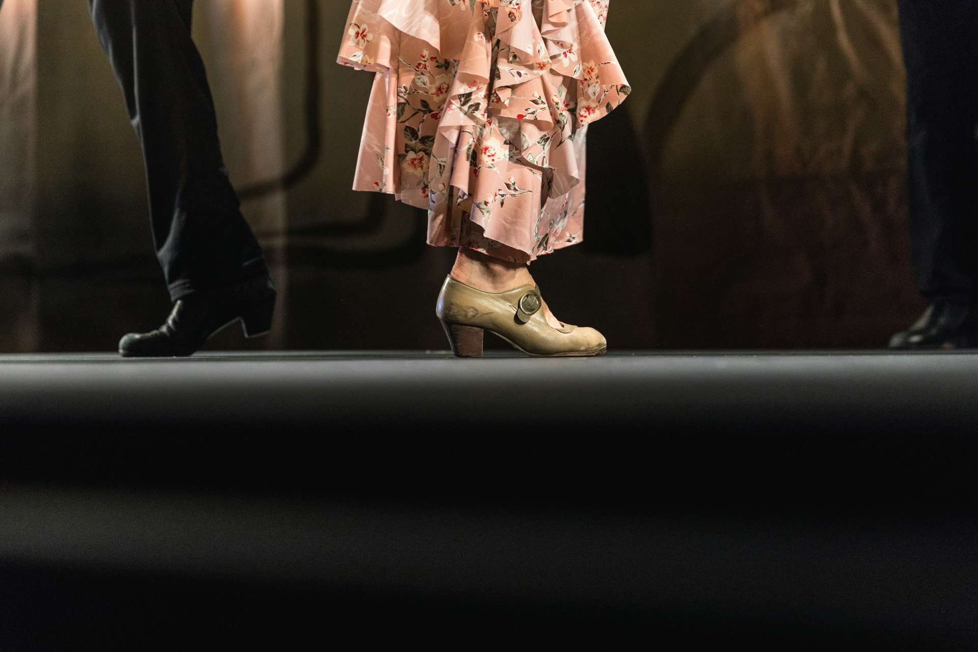Two pairs of feet of flamenco dancers.