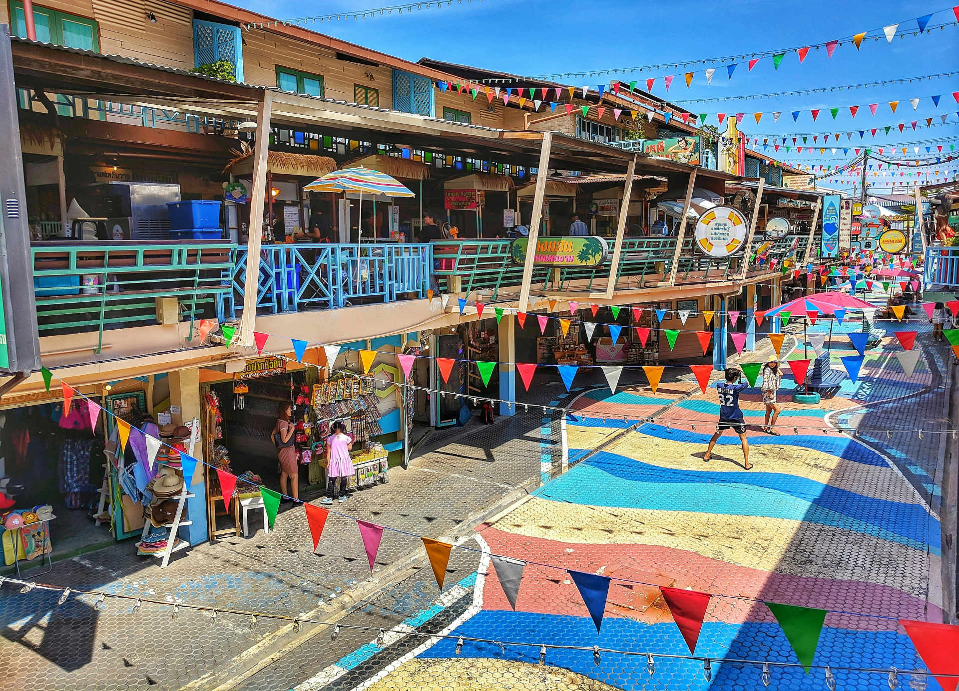 A colorful street market in Hua Hin during the day.