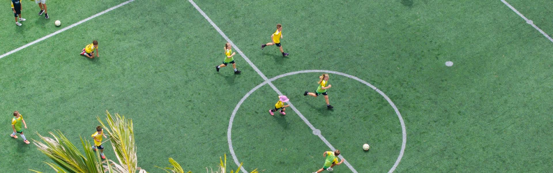Kids playing football at Avani+ Fares Maldives Resort