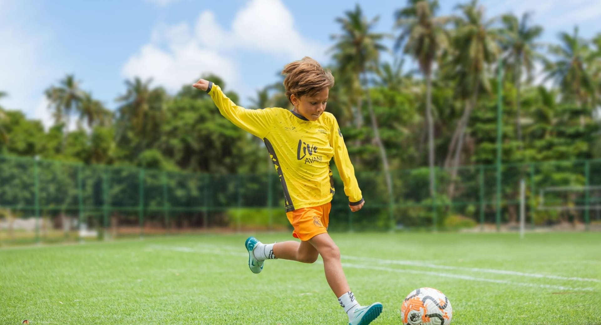 Outdoor football activity for kids at Avani+ Fares Maldives island resort