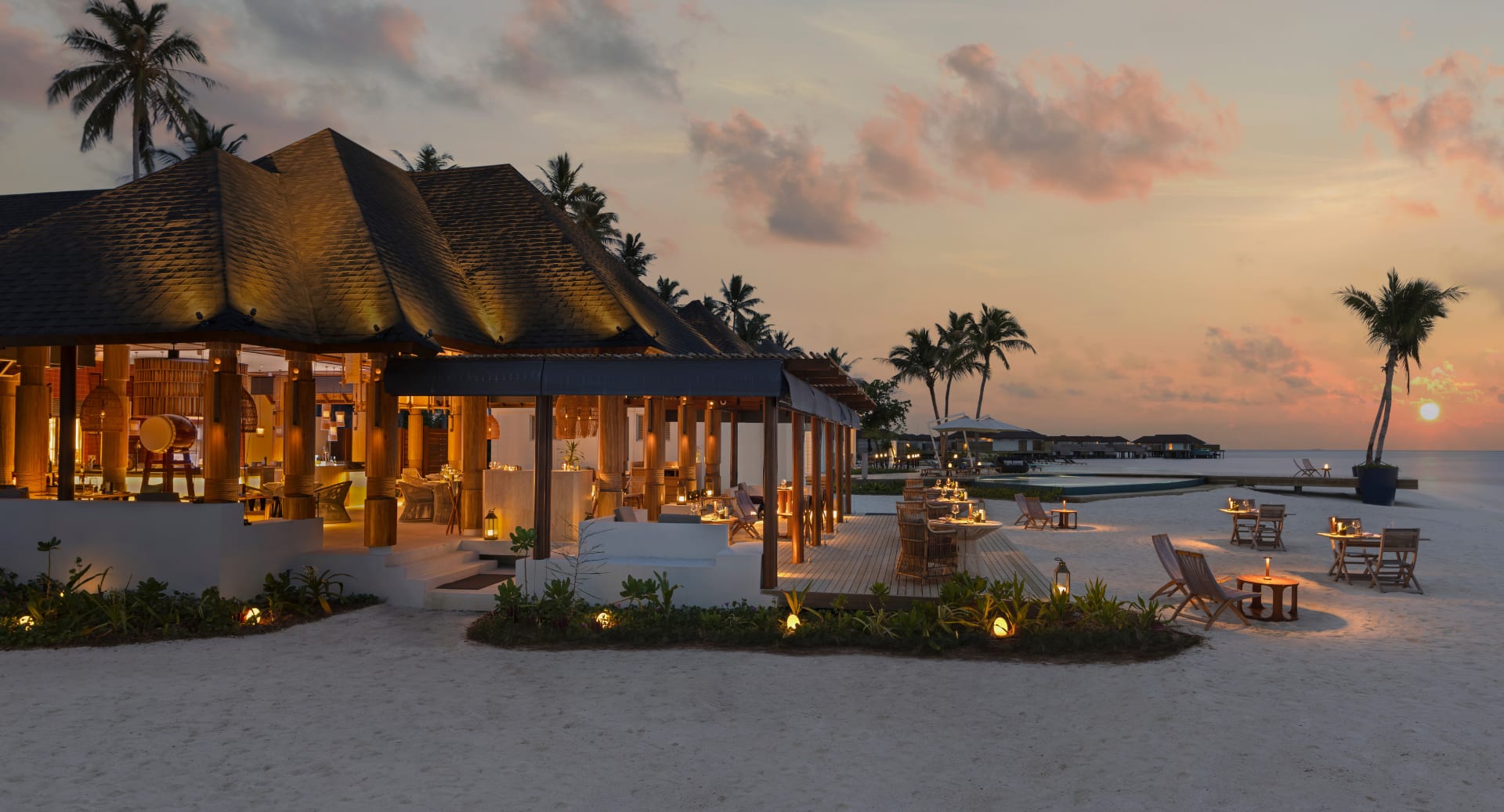 Beachfront restaurant at Avani+ Fares Maldives resort with sunset ocean views