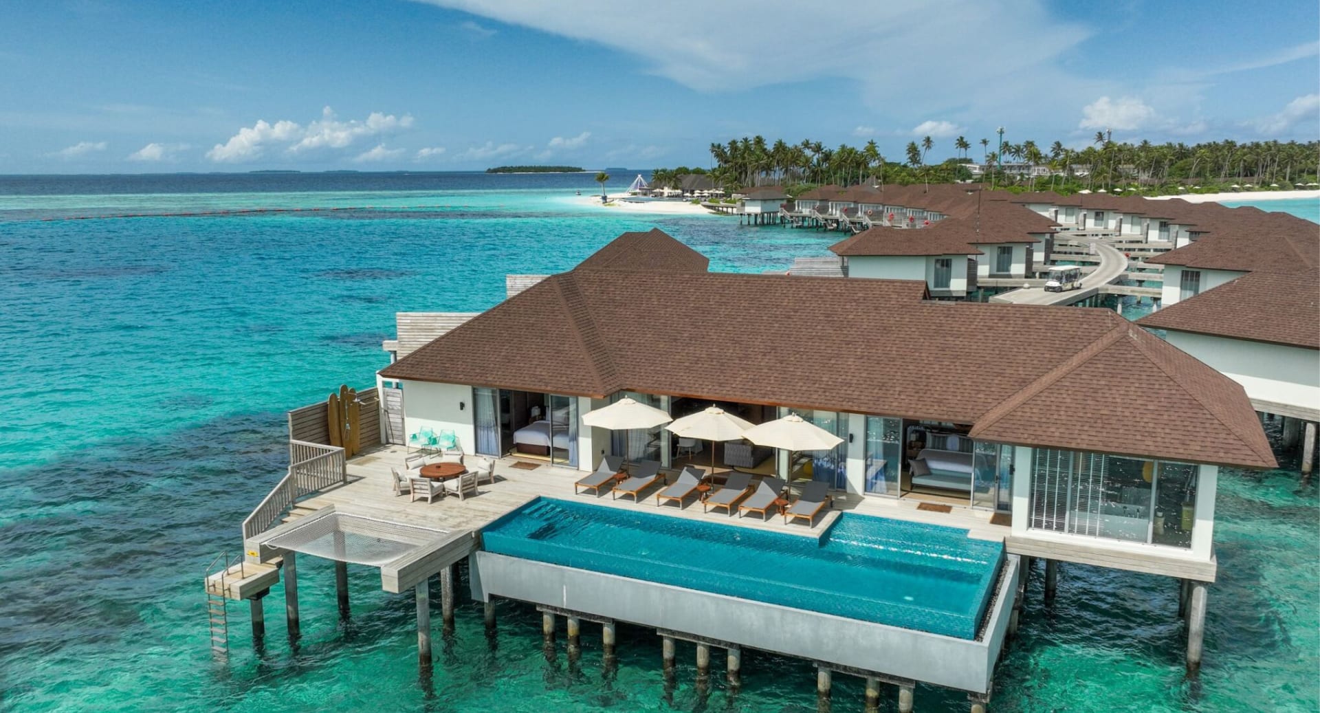 Exterior view of residence pool villa above the lagoon at Avani+ Fares Maldives.