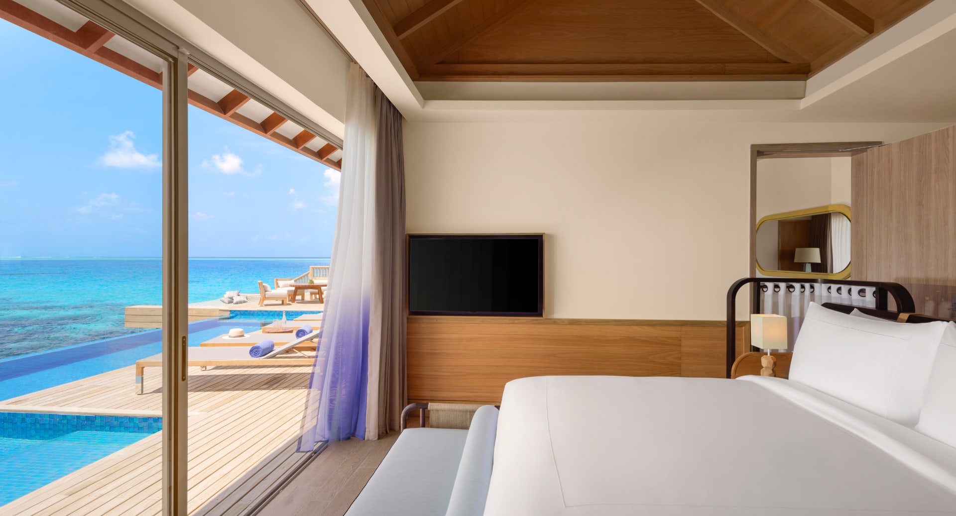 Oceanview bedroom with private pool and deck at Avani+ Fares Maldives Resort