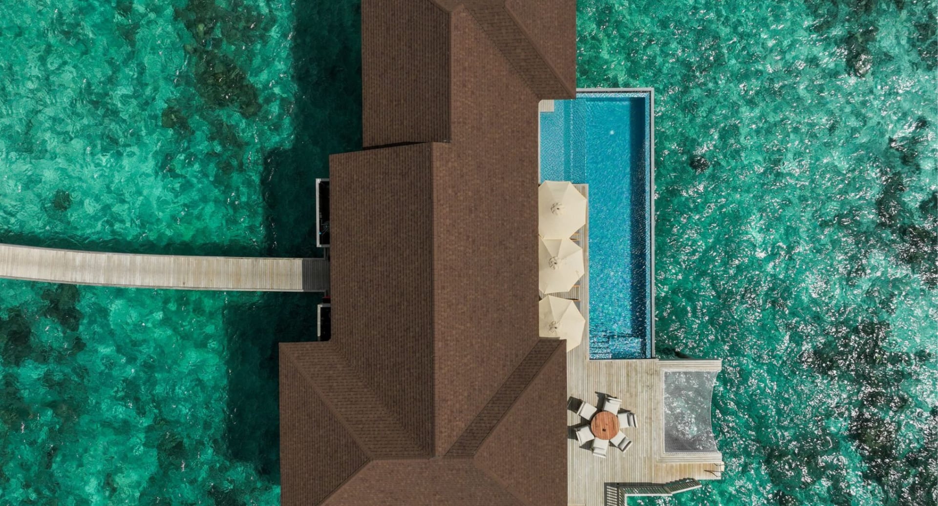 Aerial view of overwater residence with private pools at Avani+ Fares Maldives.