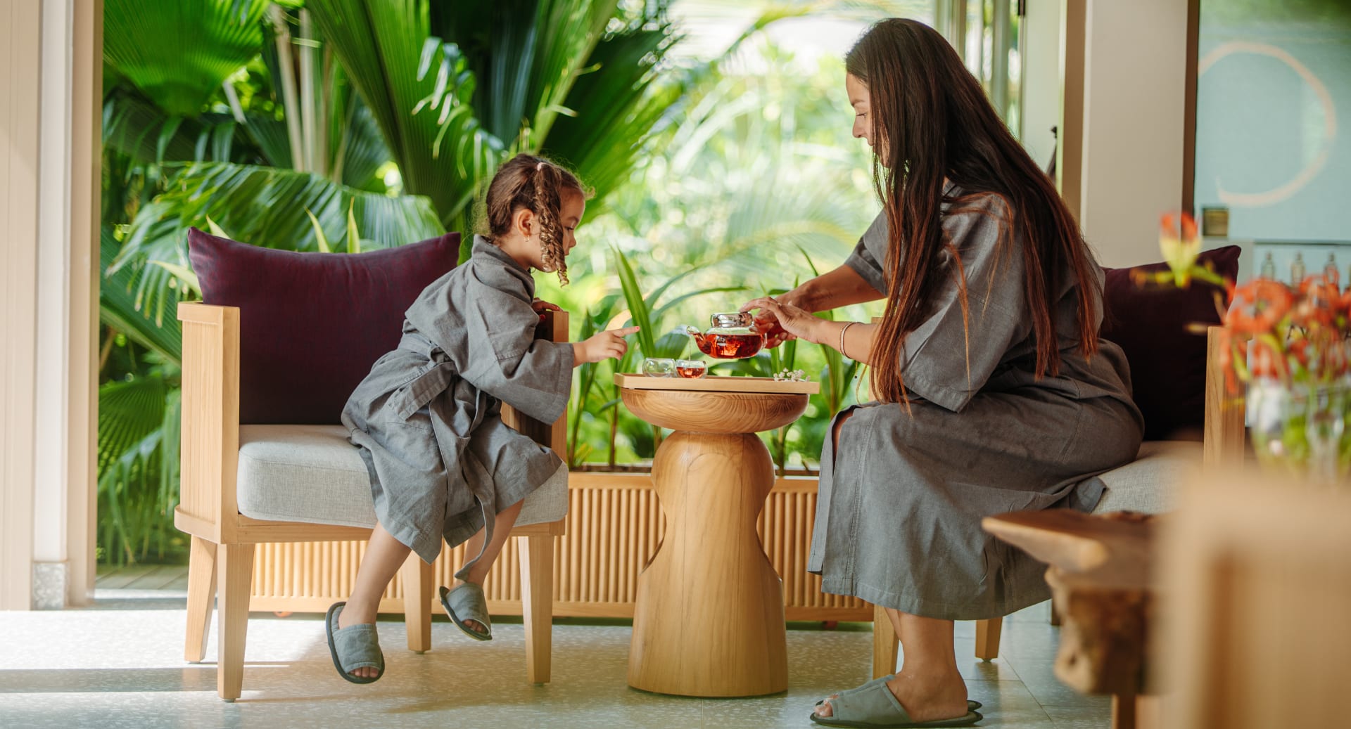 Parent and child enjoying wellness spa treatment at Avani+ Fares Maldives