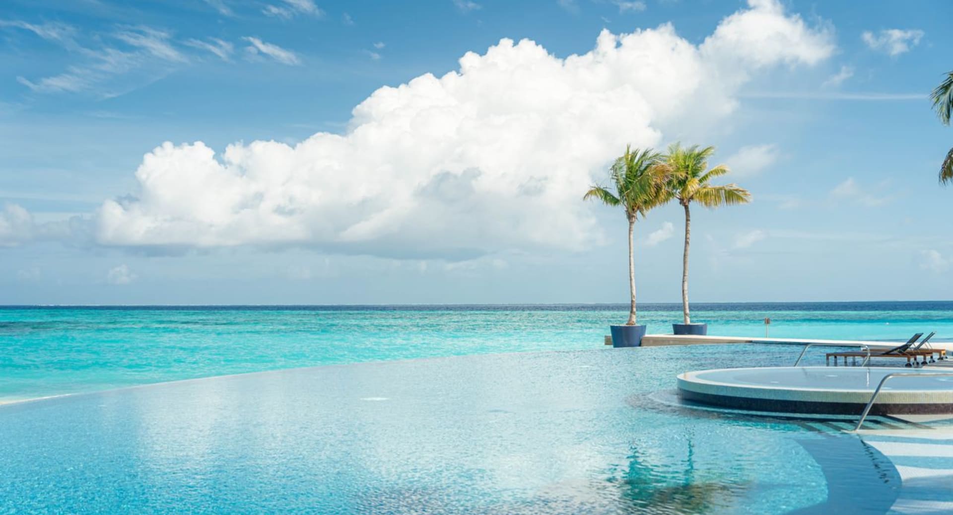 Infinity pool with ocean view at Avani+ Fares Maldives resort