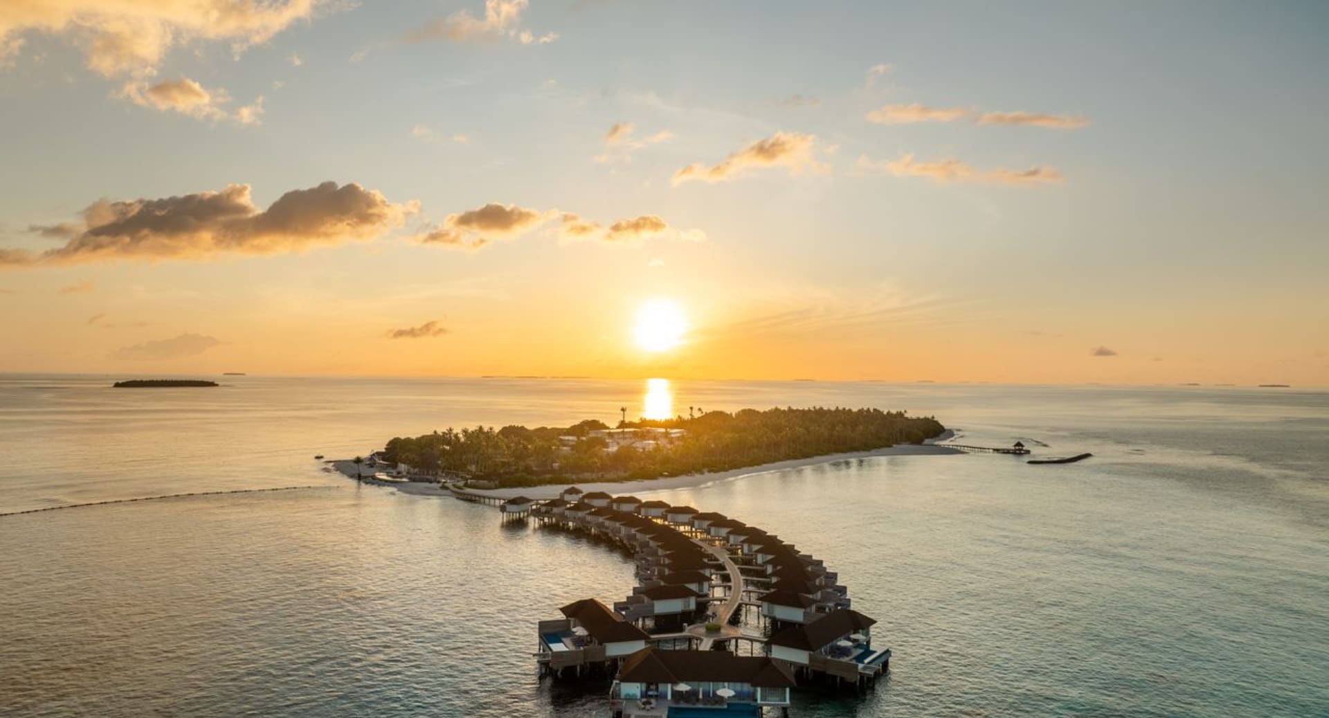 Tropical island sunrise over the ocean at Avani+ Fares Maldives island resort