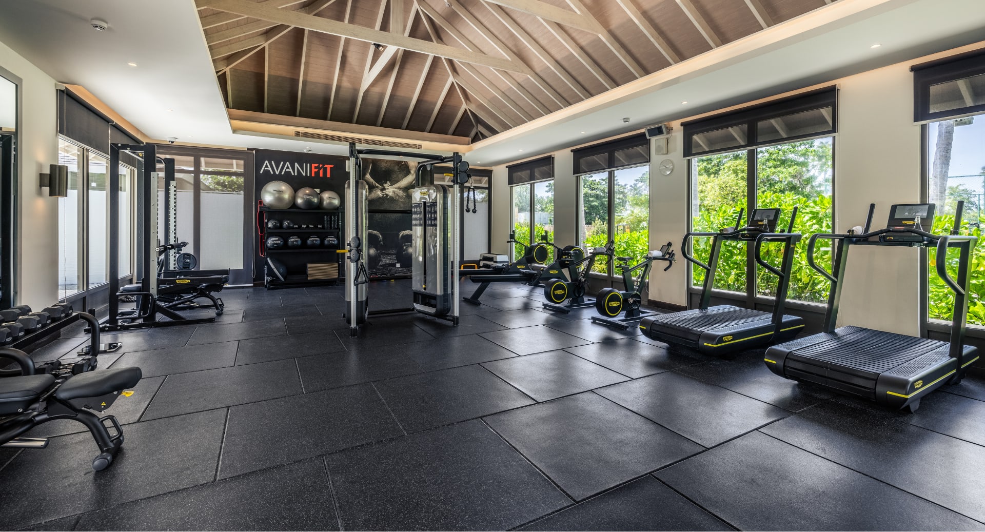 Fitness center at Avani+ Fares Maldives island resort with natural light