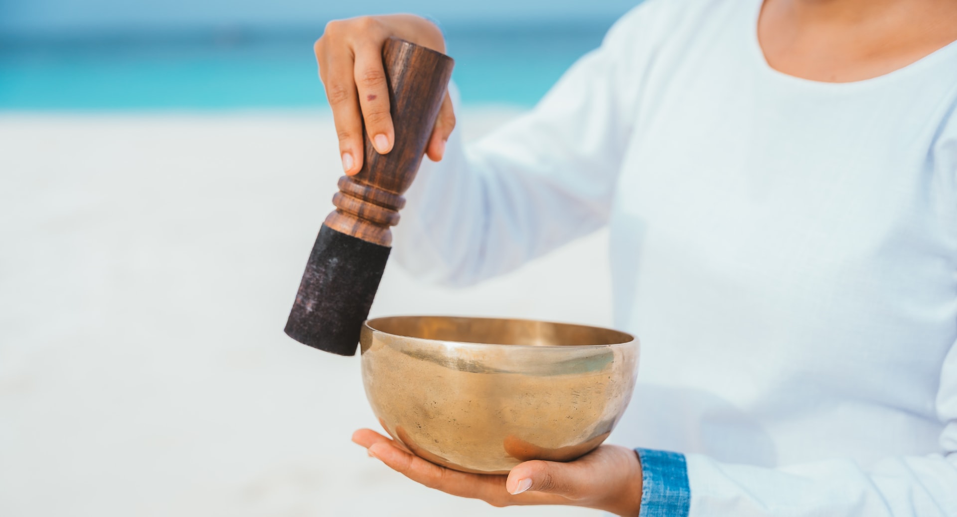 Sound healing therapy with singing bowl at Avani+ Fares Maldives resort beach