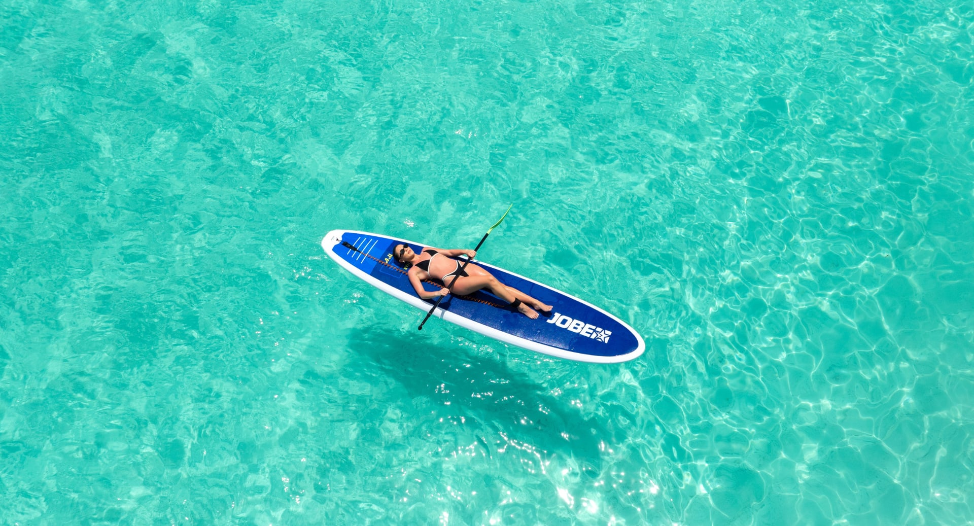Relaxing paddleboarding adventure in clear waters at Avani+ Fares Maldives