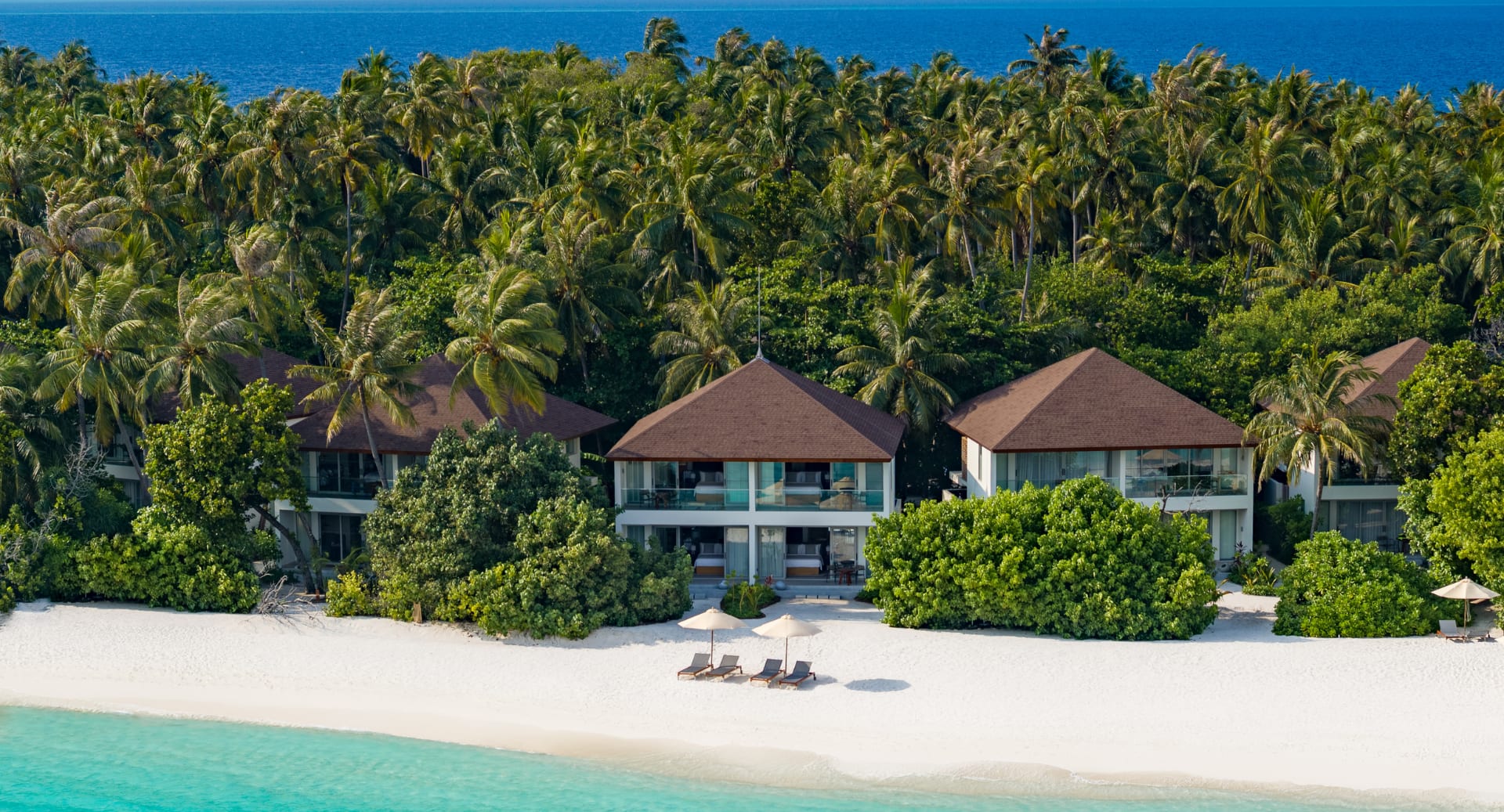 beachfront pavilion nestled among palm trees at Avani+ Fares Maldives island resort