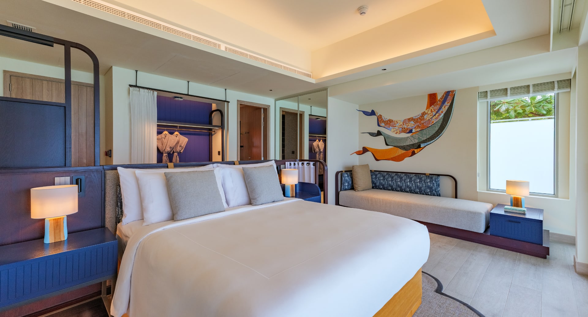 Stylish villa bedroom with vibrant d&#233;cor and king bed at Avani+ Fares Maldives Resort