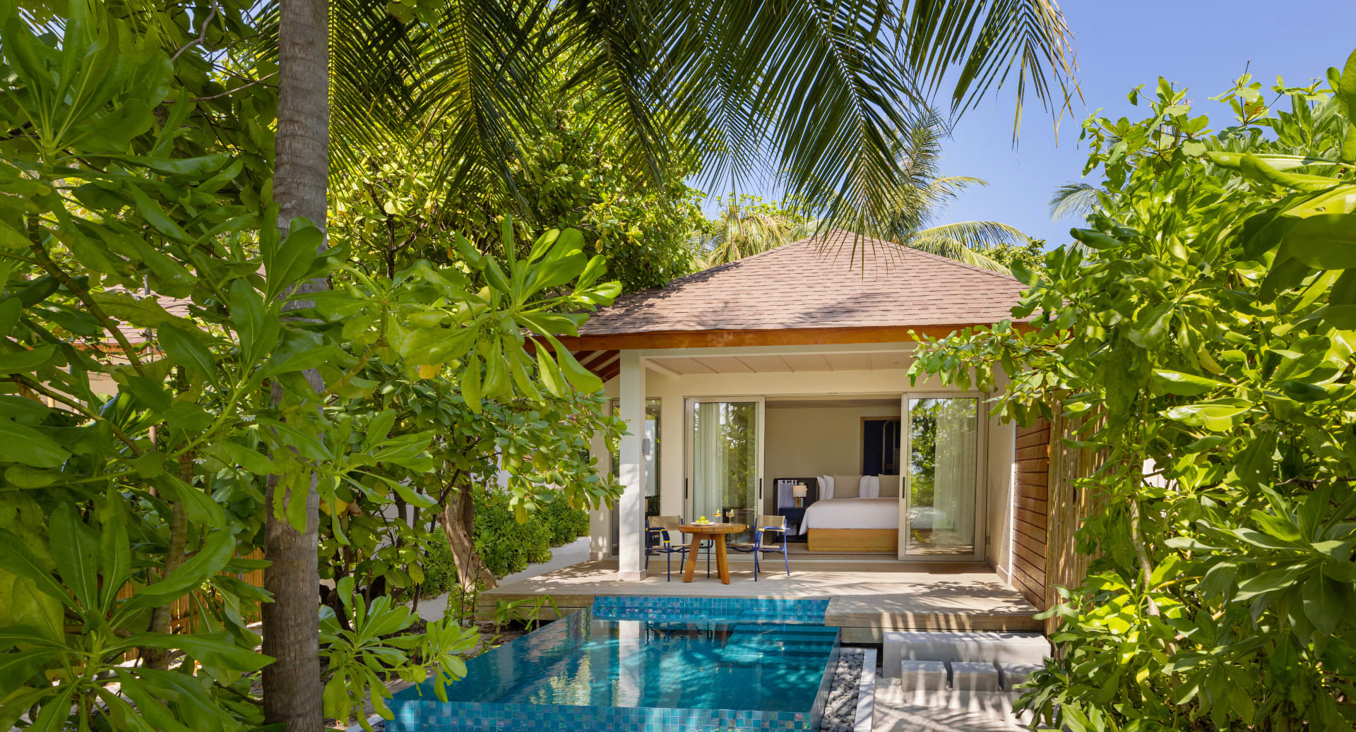 Beach pool villa surrounded by tropical gardens at Avani+ Fares Maldives resort