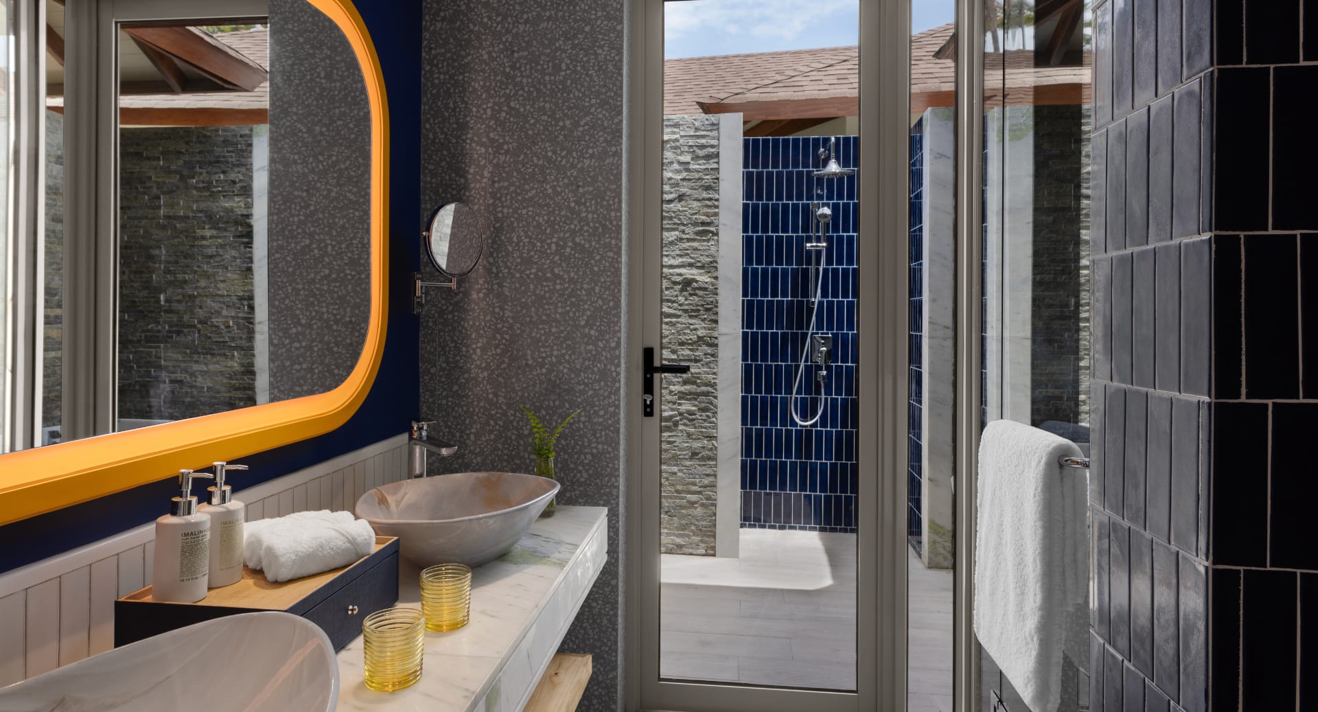 Stylish bathroom interior with modern d&#233;cor and natural light at Avani+ Fares Maldives resort