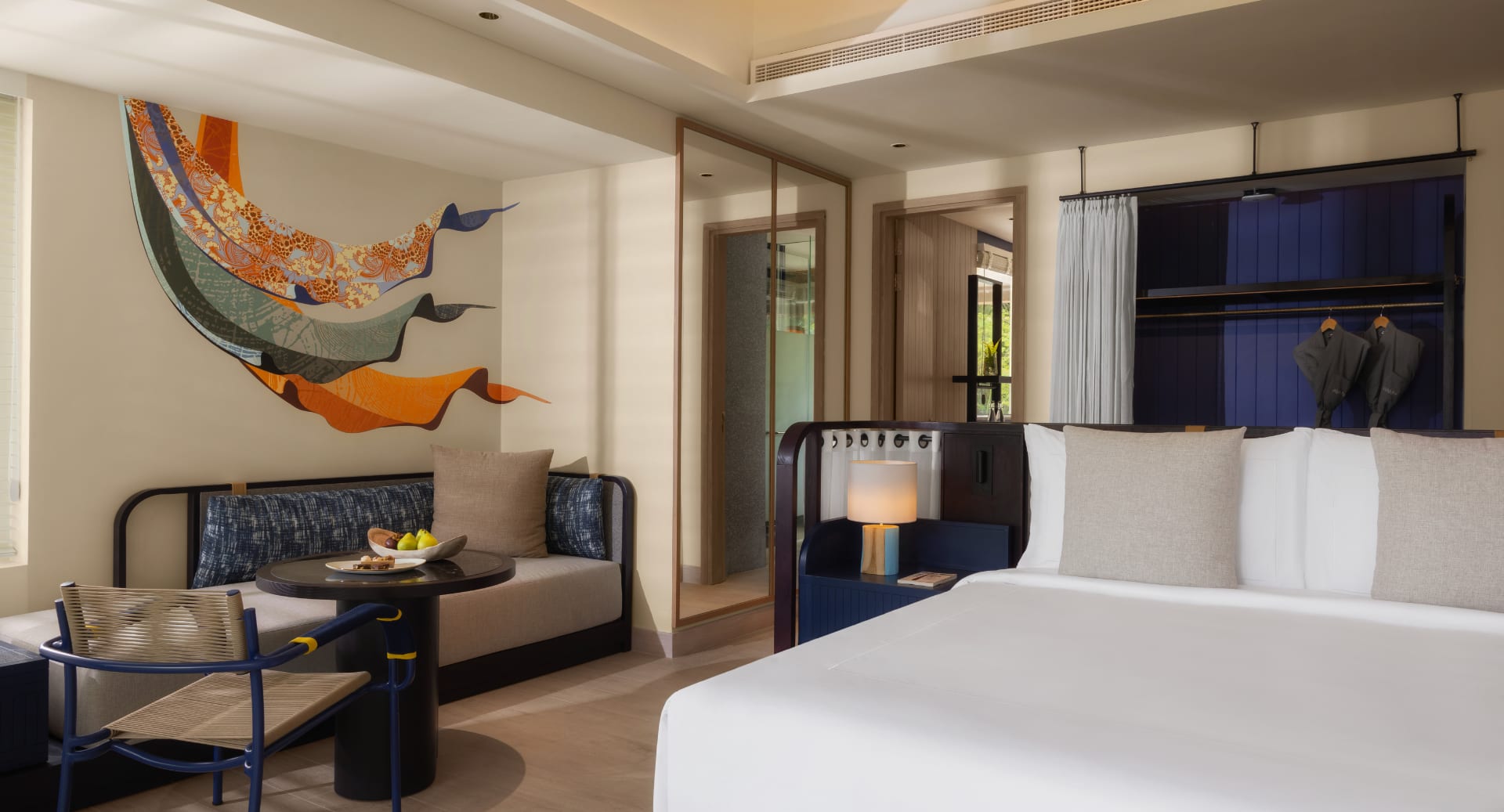 Beach villa interior design with natural light, custom furniture, and ocean-inspired art at Avani+ Fares Maldives.