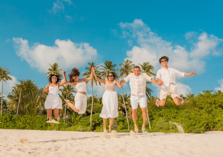Family on the beach at Avani+ Fares Maldives