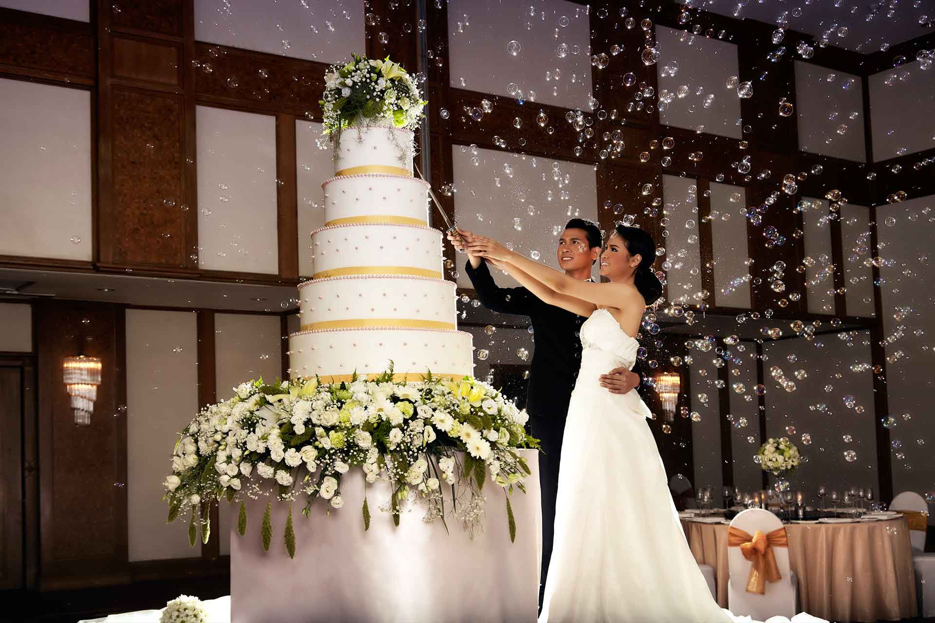 A couple cutting a wedding cake at their wedding