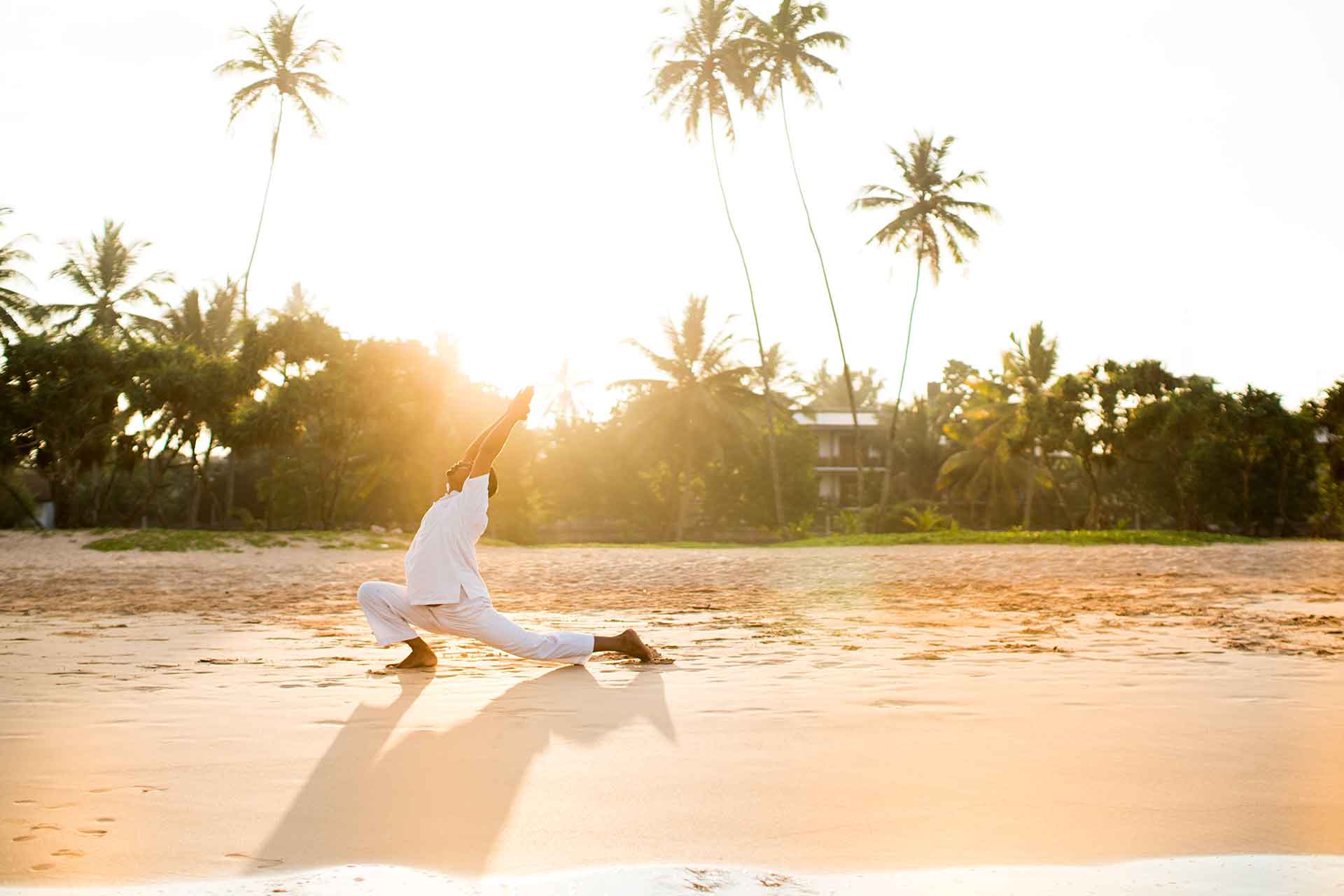 Doing yoga on the beach in the morning