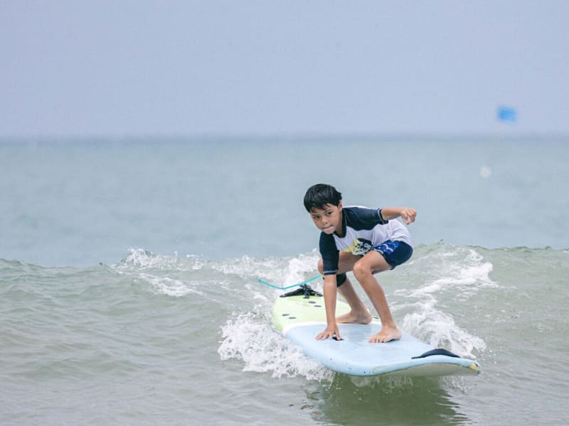 A boy on a surf board in the ocean