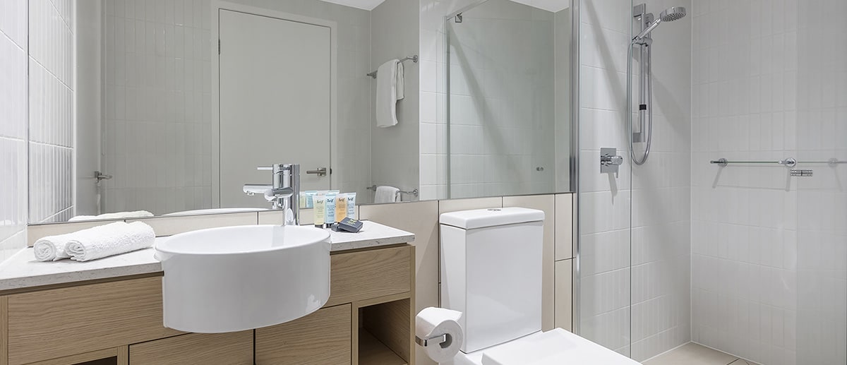Bathroom with walk-in shower at one bedroom ocean suite AVANI Broadbeach Gold Coast Hotels