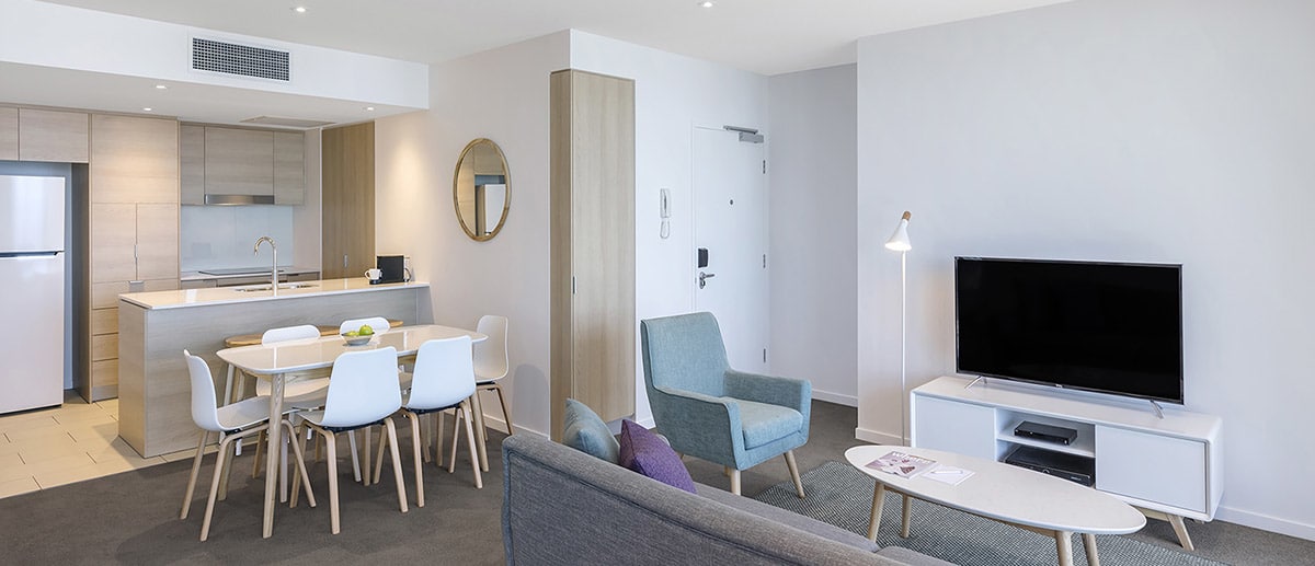 Spacious kitchen, dining and living area at the one bedroom premier ocean suite AVANI Broadbeach Gold Coast Hotels