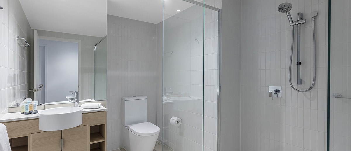 clean and spacious bathroom with walk-in shower and branded toiletries at the two bedroom suite AVANI Broadbeach Gold Coast Hotels