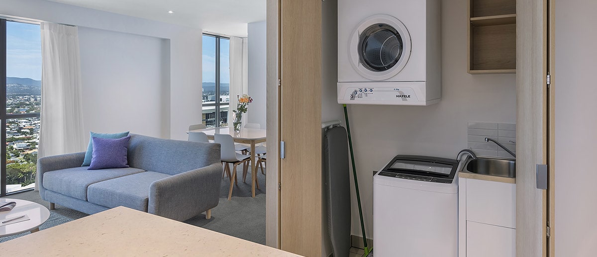 Spacious living areas with washing machine, clothes dryer and iron board in the closet at the two bedroom suite AVANI Broadbeach Gold Coast Hotels