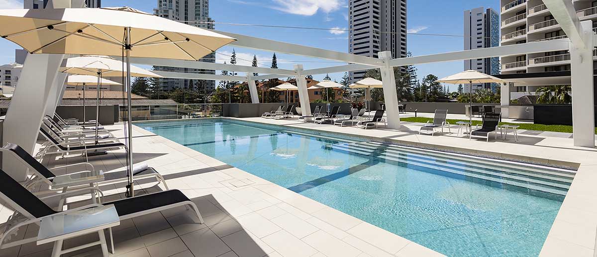 beach chairs by the outdoor pool at AVANI Broadbeach Gold Coast Hotels