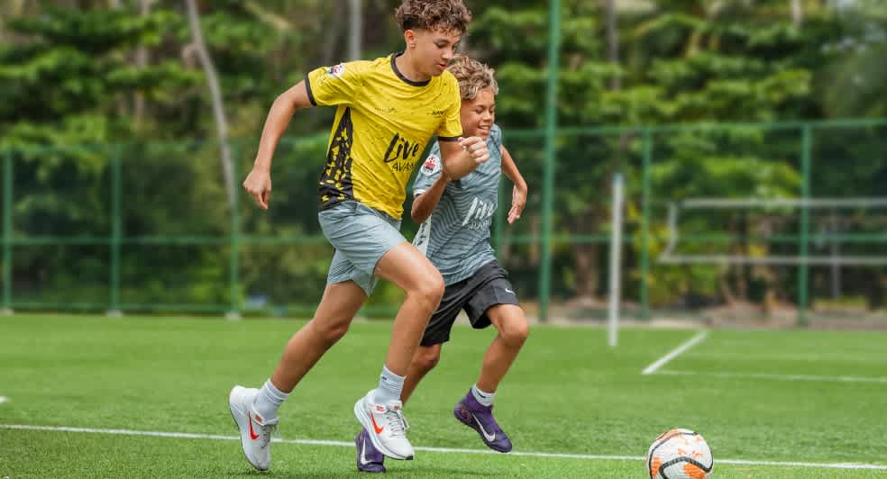 Kids playing football at Avani+ Fares Maldives Resort