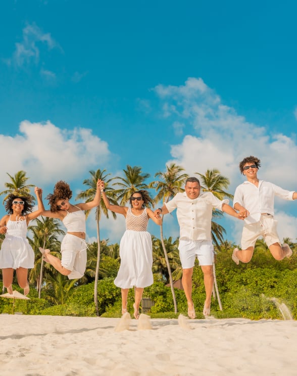 Family on the beach at Avani+ Fares Maldives