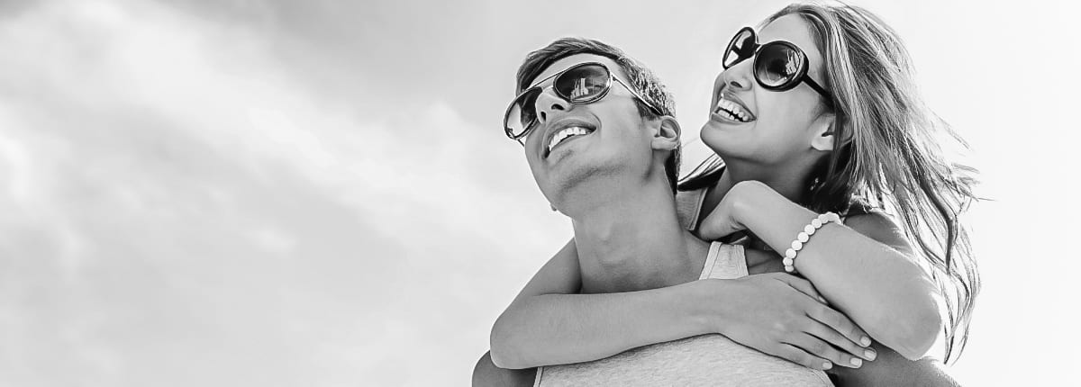 A couple wearing sunglasses on a sunny day