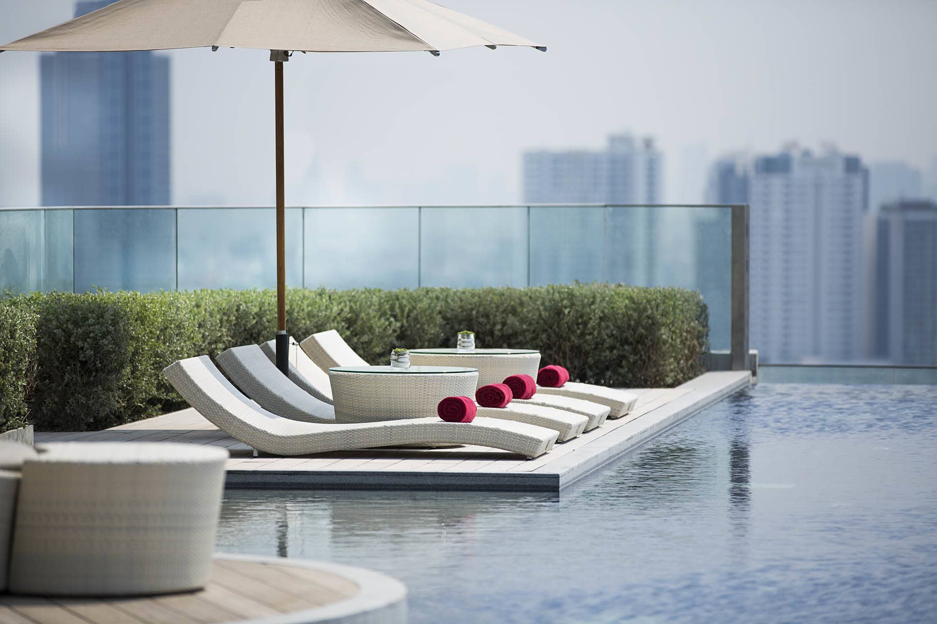 A row of sun loungers by infinity pool
