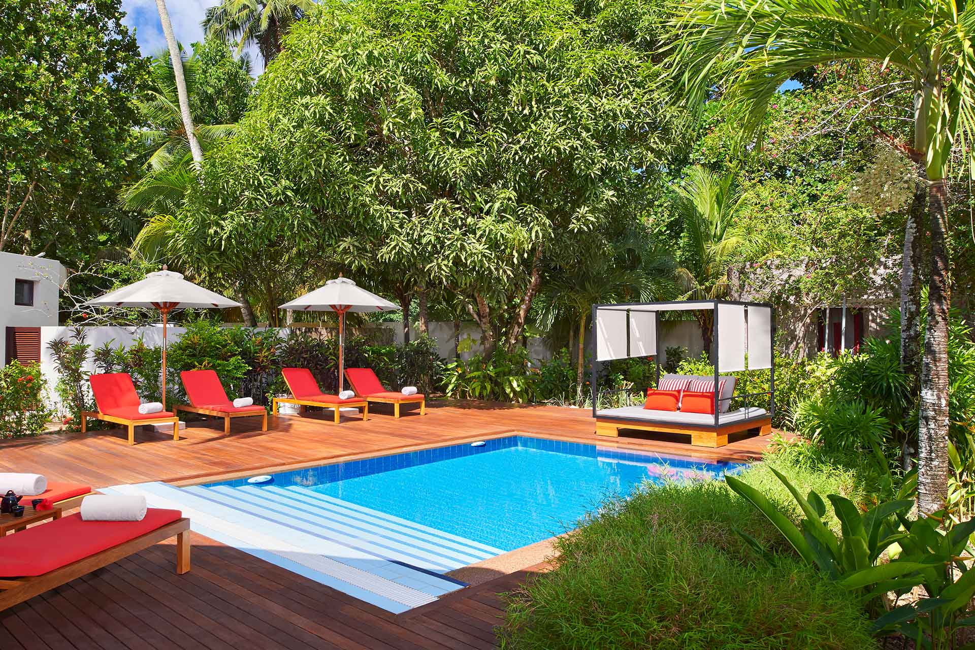 Pool side view with sun beds